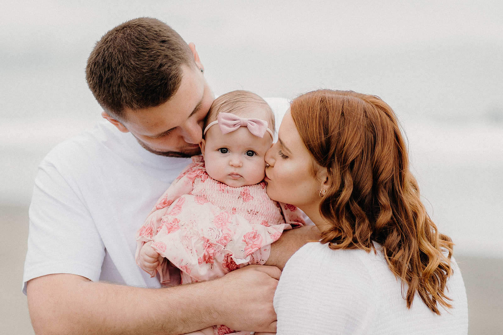 A couple with their baby at the beach during their family photoshoot with Tashina Narelle Photography, a Waikato and Auckland Family Photographer